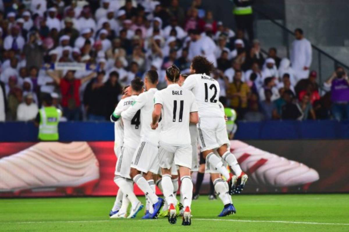 Real Madrid's players celebrate after scoring a goal during the FIFA Club World Cup final football match Spain's Real Madrid vs Abu Dhabi's Al Ain at the Zayed Sports City Stadium in Abu Dhabi, the capital of the United Arab Emirates, on December 22, 2018. (Photo by Giuseppe CACACE / AFP)