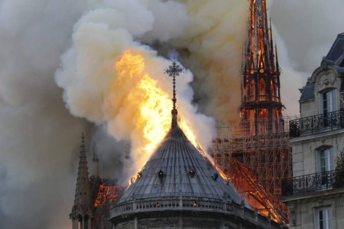 Flames burn the roof of the landmark Notre-Dame Cathedral in central Paris on April 15, 2019, potentially involving renovation works being carried out at the site, the fire service said. - A major fire broke out at the landmark Notre-Dame Cathedral in central Paris sending flames and huge clouds of grey smoke billowing into the sky, the fire service said. The flames and smoke plumed from the spire and roof of the gothic cathedral, visited by millions of people a year, where renovations are currently underway. (Photo by FRANCOIS GUILLOT / AFP)