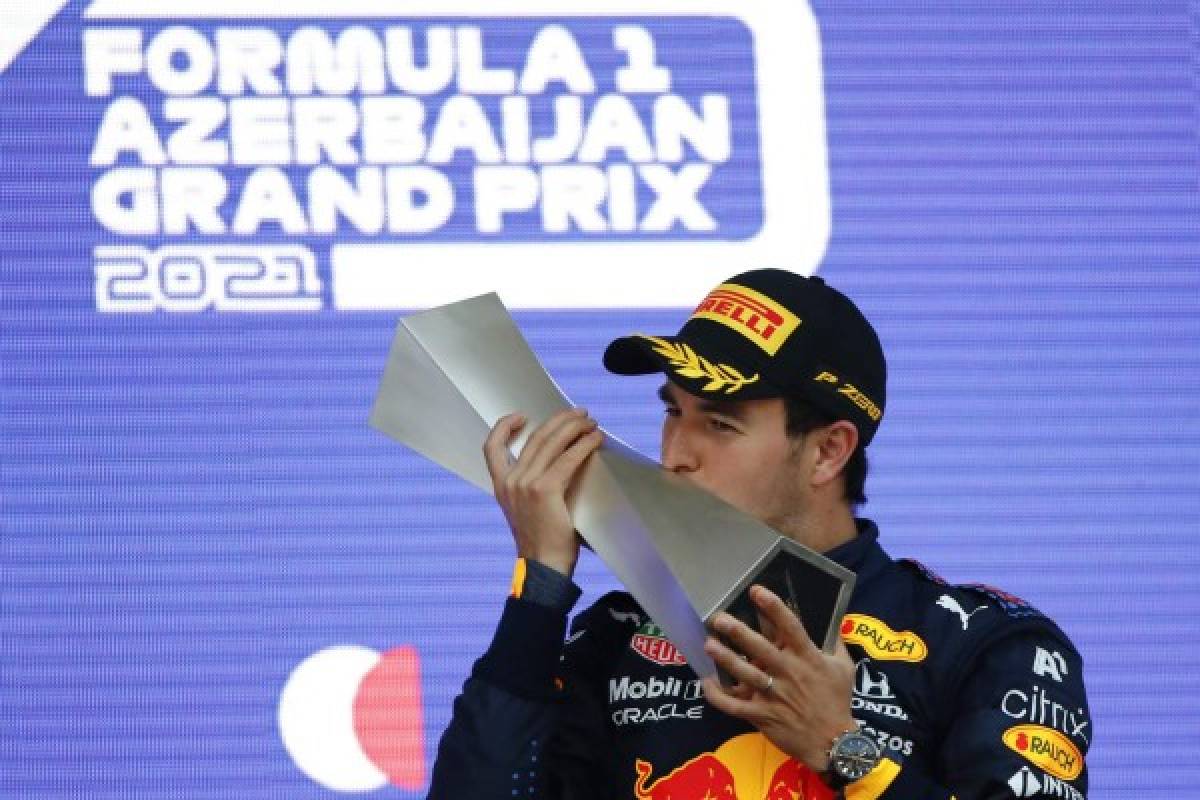 Red Bull's Mexican driver Sergio Perez celebrates on the podium after winning the Formula One Azerbaijan Grand Prix at the Baku City Circuit in Baku on June 6, 2021. (Photo by MAXIM SHEMETOV / POOL / AFP)