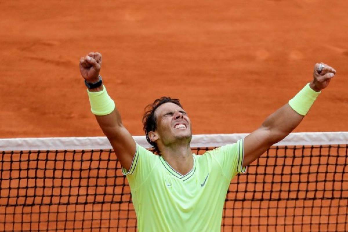 Spain's Rafael Nadal celebrates after winning against Austria's Dominic Thiem during their men's singles final match, on day fifteen of The Roland Garros 2019 French Open tennis tournament in Paris on June 9, 2019. (Photo by Thomas SAMSON / AFP)