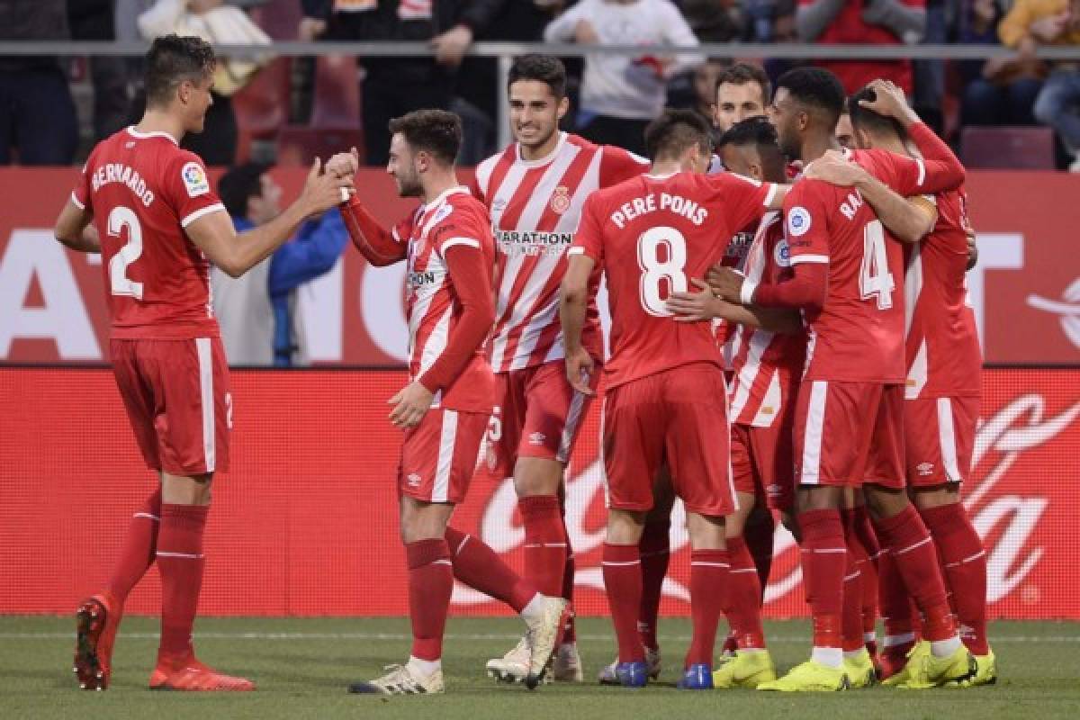 Girona's players celebrates after scoring a goal during the Spanish league football match between Girona and Club Atletico de Madrid at the Montilivi stadium in Girona on December 2, 2018. (Photo by Josep LAGO / AFP)