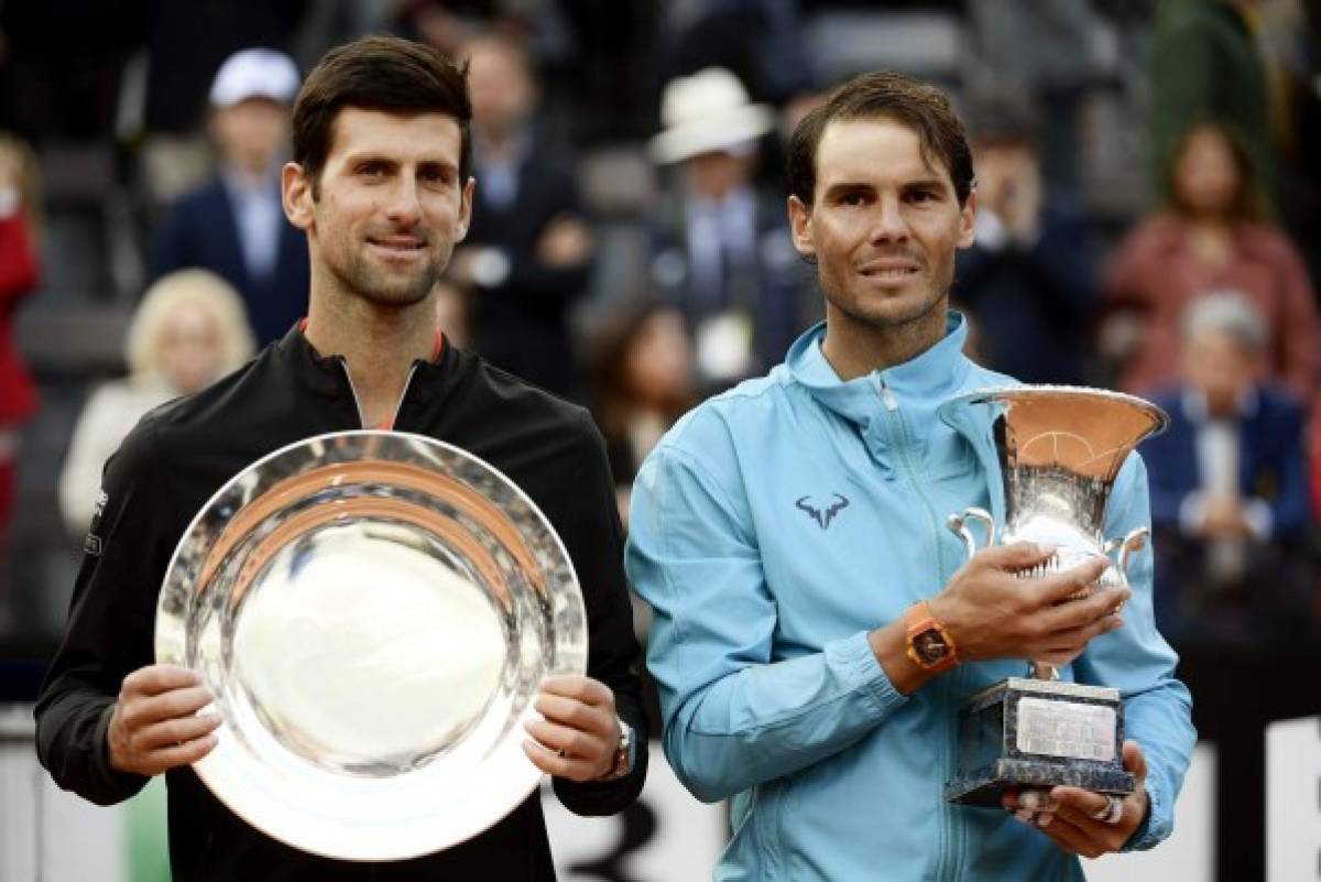 Rafael Nadal (R) of Spain poses with Novak Djokovic of Serbia after winning the ATP Masters tournament final tennis match at the Foro Italico in Rome on May 19, 2019. (Photo by Filippo MONTEFORTE / AFP)