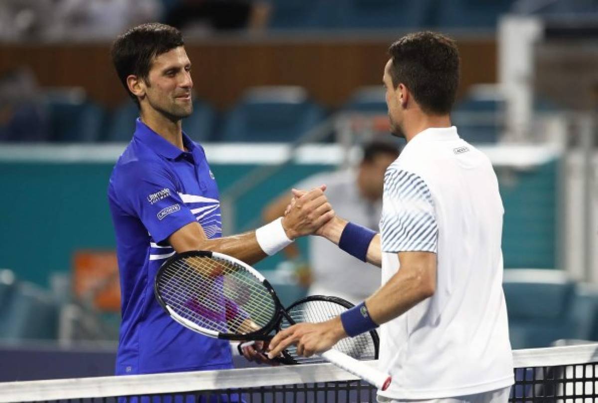 MIAMI GARDENS, FLORIDA - MARCH 26: Roberto Bautista Agut of Spain is congratulated by Novak Djokovic of Serbia after their match during the Miami Open tennis on March 26, 2019 in Miami Gardens, Florida. Julian Finney/Getty Images/AFP