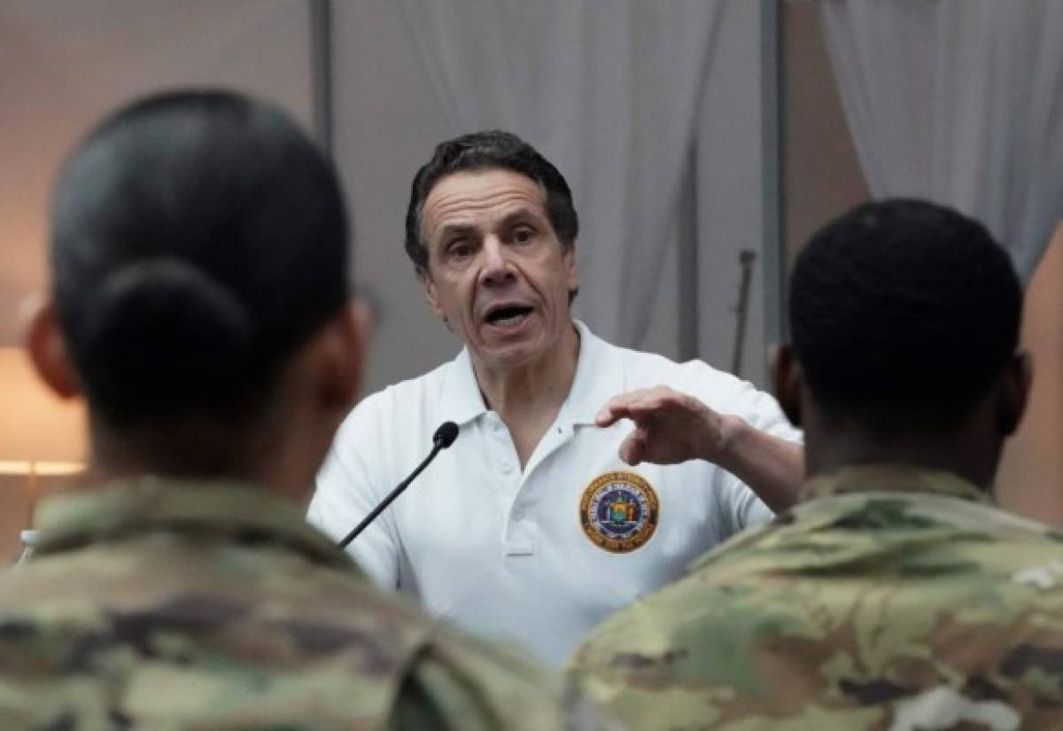 (FILES) In this file photo taken on March 27, 2020, National Guard troops listen as New York Governor Andrew Cuomo speaks to the press at the Jacob K. Javits Convention Center in New York. - Millions of New Yorkers must be tested for the new coronavirus before the state can reopen, Governor Andrew Cuomo said on April 10, 2020, as he reported a continued slowing of COVID-19. Cuomo said intensive care admissions were at their lowest since the crisis began last month but called for an 'unprecedented mobilization' of testing before residents are able to return to work. (Photo by Bryan R. Smith / AFP)
