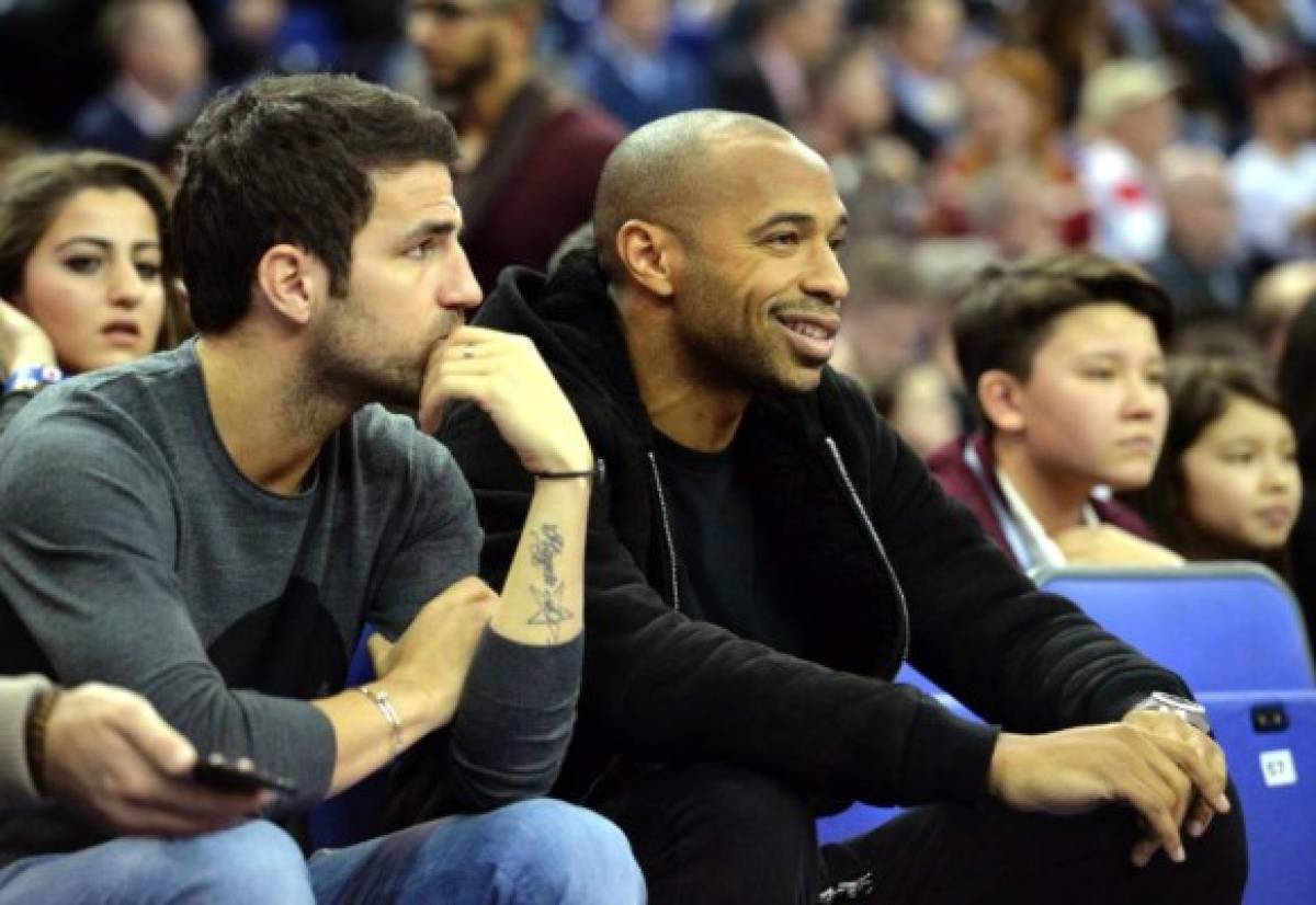 (FILES) In this file photograph taken on January 15, 2015, Chelsea footballer Cesc Fabregas (L) looks on as former footballer Thierry Henry (R) watch the 2015 NBA global game between Milwaukee Bucks and New York Knicks at the O2 Arena in London. - Spanish midfielder Cesc Fabregas is expected in Monaco on January 6, 2019, to negotiate a transfer to the French Ligue 1 club from Chelsea, sports daily L'Equipe reported January 5. (Photo by GLYN KIRK / AFP)