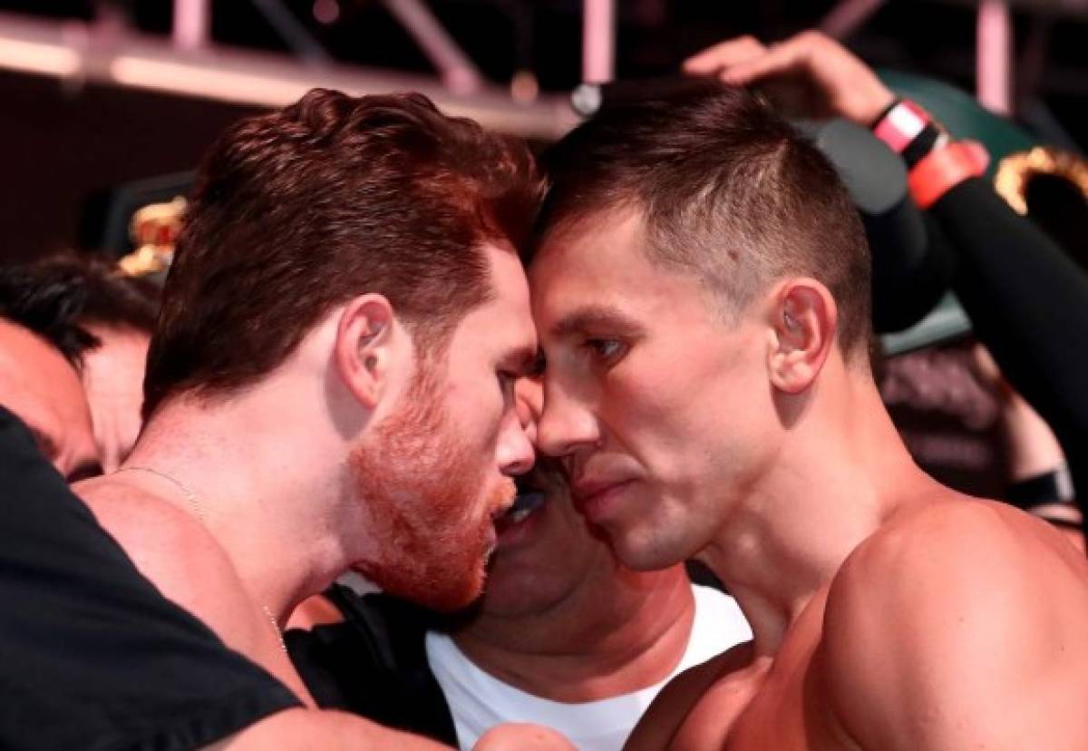 (FILES) In this file photo taken on September 14, 2018 pro boxer Canelo Alvarez (L) and WBC/WBA middleweight champion Gennady Golovkin are held back after facing off during their official weigh-in at T-Mobile Arena in Las Vegas, Nevada.September 14, 2018 Gennady Golovkin and Saul 'Canelo' Alvarez faced off for the final time ahead of their eagerly awaited rematch here Friday as they comfortably made the weight for their middleweight grudge match. / AFP PHOTO / GETTY IMAGES NORTH AMERICA / AL BELLO