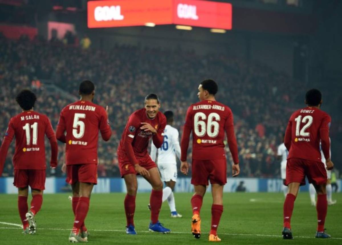 Liverpool's Dutch midfielder Georginio Wijnaldum (2L) celebrates scoring with Liverpool's Dutch defender Virgil van Dijk during the UEFA Champions League group E football match between Liverpool and RC Genk at Anfield in Liverpool, north west England on November 5, 2019. (Photo by Oli SCARFF / AFP)