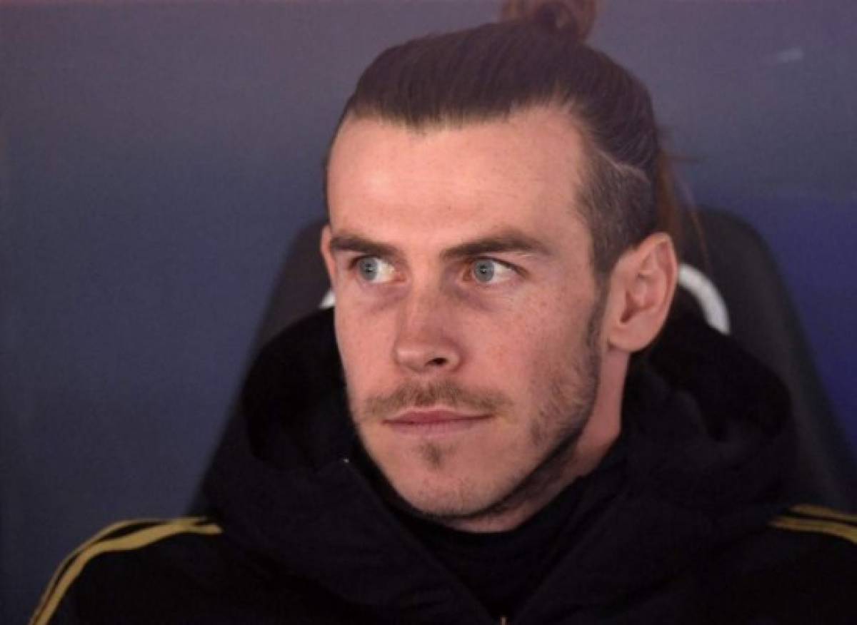 Real Madrid's Welsh forward Gareth Bale looks on as he sits on the bench during the Spanish league football match Real Madrid CF against Real Sociedad at the Santiago Bernabeu stadium in Madrid on November 23, 2019. (Photo by PIERRE-PHILIPPE MARCOU / AFP)