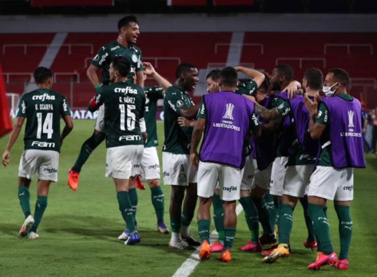 Brazil's Palmeiras Uruguayan Matias Vina (C, partially covered) celebrates with teammates after scoring against Argentina's River Plate during their Copa Libertadores semifinal football match at the Libertadores de America stadium in Avellaneda, Buenos Aires Province, Argentina, on January 5, 2021. (Photo by Juan Ignacio RONCORONI / POOL / AFP)