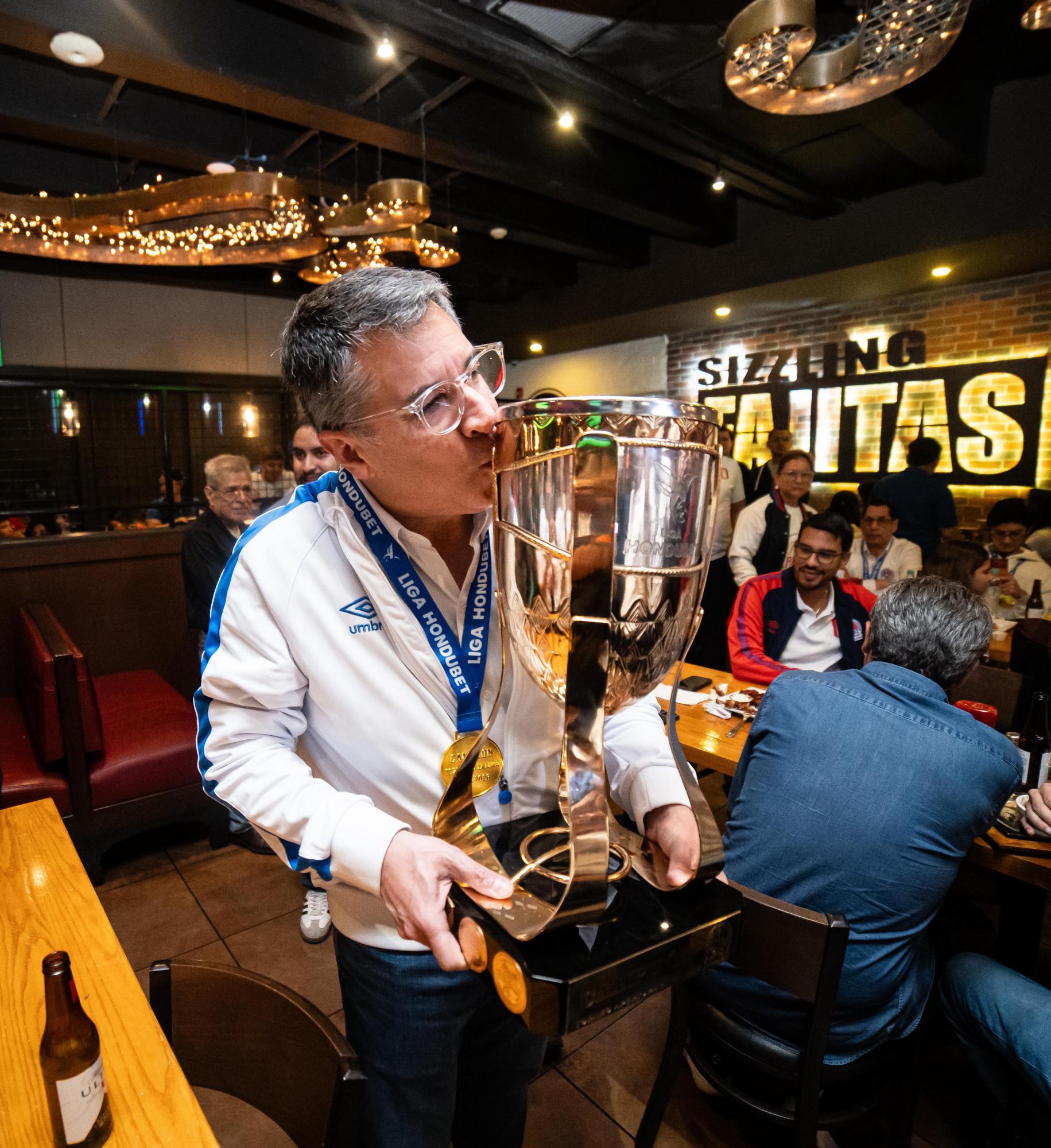 Rafael Villeda besando su décima copa de campeón como presidene del Olimpia. FOTO: Mauricio Ayala.