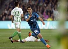 Real Madrid's Spanish midfielder Marco Asensio celebrates after scoring a goal during the Spanish league football match Real Betis vs Real Madrid at the Benito Villamarin stadium in Sevilla on February 18, 2018. / AFP PHOTO / Cristina Quicler