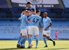 Manchester City's English defender John Stones is mobbed by teammates after scoring their second goal during the English Premier League football match between Manchester City and West Ham United at the Etihad Stadium in Manchester, north west England, on February 27, 2021. (Photo by Clive Brunskill / POOL / AFP) / RESTRICTED TO EDITORIAL USE. No use with unauthorized audio, video, data, fixture lists, club/league logos or 'live' services. Online in-match use limited to 120 images. An additional 40 images may be used in extra time. No video emulation. Social media in-match use limited to 120 images. An additional 40 images may be used in extra time. No use in betting publications, games or single club/league/player publications. /