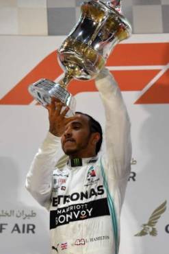 Mercedes' British driver Lewis Hamilton (C) celebrates on the podium after winning the Formula One Bahrain Grand Prix at the Sakhir circuit in the desert south of the Bahraini capital Manama, on March 31, 2019. (Photo by Andrej ISAKOVIC / AFP)