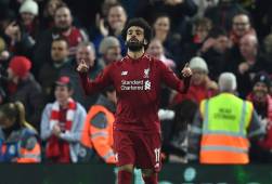 Liverpool's Egyptian midfielder Mohamed Salah celebrates scoring the opening goal during the UEFA Champions League group C football match between Liverpool and Napoli at Anfield stadium in Liverpool, north west England on December 11, 2018. (Photo by Paul ELLIS / AFP)