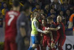 Players of Canadian Toronto celebrate after scoring against Mexico's Tigres during the Concacaf Champions League football match at the Universitario stadium in Monterrey, Mexico, March 13, 2018. / AFP PHOTO / Julio Cesar AGUILAR