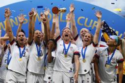 USA's players celebrate with the trophy after the France 2019 Womens World Cup football final match between USA and the Netherlands, on July 7, 2019, at the Lyon Stadium in Lyon, central-eastern France. (Photo by FRANCK FIFE / AFP)