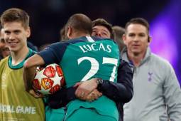 Tottenham's Brazilian forward Lucas celebrates the victory with Tottenham's Argentine coach Mauricio Pochettino at the end of the UEFA Champions League semi-final second leg football match between Ajax Amsterdam and Tottenham Hotspur at the Johan Cruyff Arena, in Amsterdam, on May 8, 2019. - Tottenham fought back from three goals down on aggregate to stun Ajax 3-2 and set up a Champions League final against Liverpool. (Photo by Adrian DENNIS / AFP)