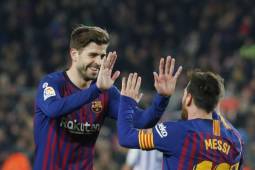 Barcelona's Argentinian forward Lionel Messi (R) celebrates with Barcelona's Spanish defender Gerard Pique after scoring a goal during the Spanish League football match between Barcelona and Real Valladolid at the Camp Nou stadium in Barcelona on February 16, 2019. (Photo by Pau Barrena / AFP)