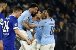 Manchester City's German midfielder Leroy Sane (C) is congratulated by teammates after scoring a goal during the UEFA Champions League round of 16 first leg football match between Schalke 04 and Manchester City on February 20, 2019 in Gelsenkirchen, Germany. (Photo by Odd ANDERSEN / AFP)