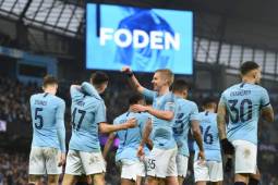 Manchester City's English midfielder Phil Foden (2nd L) celebrates with teammates after scoring their second goal during the English FA Cup third round football match between Manchester City and Rotherham United at the Etihad Stadium in Manchester, north west England, on January 6, 2019. (Photo by Oli SCARFF / AFP) / RESTRICTED TO EDITORIAL USE. No use with unauthorized audio, video, data, fixture lists, club/league logos or 'live' services. Online in-match use limited to 120 images. An additional 40 images may be used in extra time. No video emulation. Social media in-match use limited to 120 images. An additional 40 images may be used in extra time. No use in betting publications, games or single club/league/player publications. /