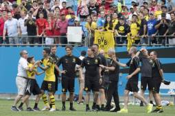 Borussia Dortmund's Christian Pulisic (3rd L) rushes out on the pitch as a fan is detained during the 2018 International Champions Cup at Bank of America Stadium in Charlotte, North Carolina, on July 22, 2018. / AFP PHOTO / JIM WATSON