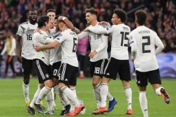 Germany's players celebrate after scoring their second goal during the UEFA Euro 2020 Group C qualification football match between The Netherlands and Germany at the Johan Cruyff Arena in Amsterdam on March 24, 2019. (Photo by EMMANUEL DUNAND / AFP)