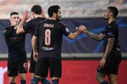 Manchester City's English midfielder Phil Foden (L) is congratulated by teammates after scoring a goal during the UEFA Champions League group stage football match between Olympiakos and Manchester City, on November 25, 2020 at Georgios-Karaiskakis stadium in Piraeus, near Athens. (Photo by ARIS MESSINIS / AFP)