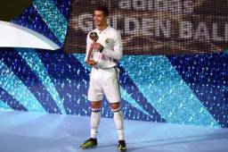 Cristiano Ronaldo posando con el trofeo que lo distingue como el jugador más destacado del certamen.