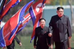 (FILES) This file photo taken on July 29, 2017 shows people watching as coverage of an ICBM missile test is displayed on a screen in a public square in Pyongyang.North Korea slammed fresh UN sanctions imposed over its missile tests as an 'act of war' on December 24, 2017, its first response to the latest diplomatic move to punish Pyongyang's ever-accelerating weapons drive. / AFP PHOTO / Kim Won-Jin