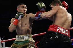 NEW YORK, NEW YORK - DECEMBER 14: Teofimo Lopez Jr punches Richard Commey during their bout for Commey's IBF lightweight title at Madison Square Garden on December 14, 2019 in New York City. Al Bello/Getty Images/AFP== FOR NEWSPAPERS, INTERNET, TELCOS & TELEVISION USE ONLY ==