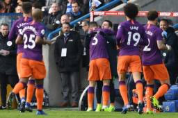 Manchester City's Brazilian defender Danilo (C) goes over to celebrate with Manchester City's Portuguese midfielder Bernardo Silva on the touchline after scoring the opening goal of the English Premier League football match between Huddersfield Town and Manchester City at the John Smith's stadium in Huddersfield, northern England on January 20, 2019. (Photo by Paul ELLIS / AFP) / RESTRICTED TO EDITORIAL USE. No use with unauthorized audio, video, data, fixture lists, club/league logos or 'live' services. Online in-match use limited to 120 images. An additional 40 images may be used in extra time. No video emulation. Social media in-match use limited to 120 images. An additional 40 images may be used in extra time. No use in betting publications, games or single club/league/player publications. /