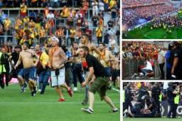 Lamentable lo que ha ocurrido en el juego entre el Lens y el Lille en Francia. Aficionados invadieron la cancha. FOTOS: AFP.