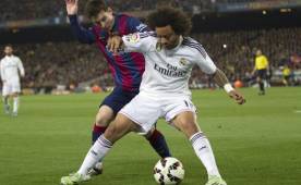 Marcelo, siendo marcado por Lionel Messi en el clásico español.