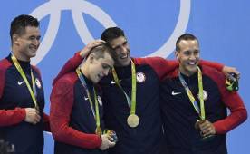 El equipo de natación masculino de los Estados Unidos celebra la obtención de sus cuatro medallas de oro que, antes de ser entregadas, tenían un valor de 2,400 dólares entre todas.