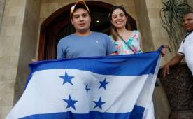 Jorge Luis Pinto Jr y Verónica Pinto posan con la bandera de Honduras, mostrando su apoyo a la Bicolor.