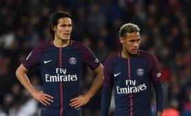(FILES) This file photo taken on September 18, 2017 shows Paris Saint-Germain's Uruguayan forward Edinson Cavani (L) and Paris Saint-Germain's Brazilian forward Neymar reacting during the French Ligue 1 football match between Paris Saint-Germain (PSG) and Lyon (OL) at the Parc des Princes stadium in Paris. Paris Saint-Germain kept their perfect start to the season going, but the 2-0 win over Lyon also laid bare certain tensions in their all-star front line. / AFP PHOTO / FRANCK FIFE
