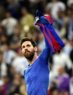 Barcelona's Argentinian forward Lionel Messi celebrates a goal during the Spanish league football match Real Madrid CF vs FC Barcelona at the Santiago Bernabeu stadium in Madrid on April 23, 2017. / AFP PHOTO / GERARD JULIEN
