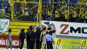 Jugadores del Real España y policía intentaron contener a los enfurecidos aficionados durante el clásico contra Olimpia. Foto DIEZ