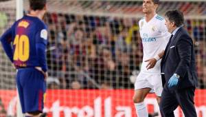Cristiano Ronaldo, ante la mirada de Messi, sale atendido por una persona del cuerpo médico del Real Madrid.