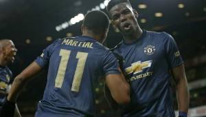 Manchester United's French striker Anthony Martial (L) celebrates with Manchester United's French midfielder Paul Pogba (R) after scoring their third goal during the English FA Cup fourth round football match between Arsenal and Manchester United at the Emirates Stadium in London on January 25, 2019. (Photo by Ian KINGTON / IKIMAGES / AFP) / RESTRICTED TO EDITORIAL USE. No use with unauthorized audio, video, data, fixture lists, club/league logos or 'live' services. Online in-match use limited to 45 images, no video emulation. No use in betting, games or single club/league/player publications.