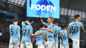 Manchester City's English midfielder Phil Foden (2nd L) celebrates with teammates after scoring their second goal during the English FA Cup third round football match between Manchester City and Rotherham United at the Etihad Stadium in Manchester, north west England, on January 6, 2019. (Photo by Oli SCARFF / AFP) / RESTRICTED TO EDITORIAL USE. No use with unauthorized audio, video, data, fixture lists, club/league logos or 'live' services. Online in-match use limited to 120 images. An additional 40 images may be used in extra time. No video emulation. Social media in-match use limited to 120 images. An additional 40 images may be used in extra time. No use in betting publications, games or single club/league/player publications. /