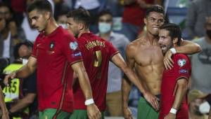 Portugal's forward Cristiano Ronaldo (2ndR) celebrates with his teammates after scoring a goal during the FIFA World Cup Qatar 2022 European qualifying round group A football match between Portugal and Republic of Ireland at the Algarve stadium in Loule, near Faro, southern Portugal, on September 1, 2021. (Photo by CARLOS COSTA / AFP)