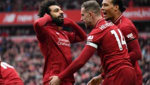 Liverpool's Egyptian midfielder Mohamed Salah (L) celebrates with Liverpool's English midfielder Jordan Henderson (2nd R) and Liverpool's Dutch defender Virgil van Dijk (R) after scoring their second goal during the English Premier League football match between Liverpool and Chelsea at Anfield in Liverpool, north west England on April 14, 2019. (Photo by Paul ELLIS / AFP) / RESTRICTED TO EDITORIAL USE. No use with unauthorized audio, video, data, fixture lists, club/league logos or 'live' services. Online in-match use limited to 120 images. An additional 40 images may be used in extra time. No video emulation. Social media in-match use limited to 120 images. An additional 40 images may be used in extra time. No use in betting publications, games or single club/league/player publications. /