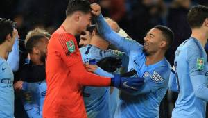 Manchester City's Brazilian striker Gabriel Jesus (R) celebrates with Manchester City's Kosovan goalkeeper Arijanet Muric on the pitch after the English League Cup quarter-final football match between Leicester City and Manchester City at King Power Stadium in Leicester, central England on December 18, 2018. - Manchester City won 3-1 on penalties after the game finished 1-1. (Photo by Lindsey PARNABY / AFP) / RESTRICTED TO EDITORIAL USE. No use with unauthorized audio, video, data, fixture lists, club/league logos or 'live' services. Online in-match use limited to 120 images. An additional 40 images may be used in extra time. No video emulation. Social media in-match use limited to 120 images. An additional 40 images may be used in extra time. No use in betting publications, games or single club/league/player publications. /
