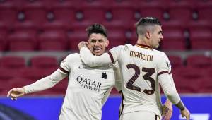 Roma's Brazilian defender Roger (L) celebrates with Roma's Italian defender Gianluca Mancini after scoring a goal during the UEFA Europa League quarter-final football match between Ajax Amsterdam and AS Roma at the Johan Cruijff Arena in Amsterdam on April 8, 2021. (Photo by JOHN THYS / AFP)