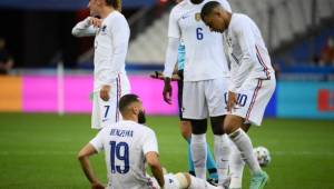 France's forward Kylian Mbappe (R) looks at France's forward Karim Benzema, injured, during the friendly football match France vs Bulgaria ahead of the Euro 2020 tournament, at Stade De France in Saint-Denis, on the outskirts of Paris on June 8, 2021. (Photo by FRANCK FIFE / AFP)