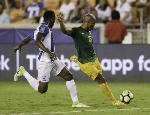HOUSTON, TX - JULY 11: Florent Malouda #5 of French Guiana shoots on goal as Anthony Lozano #9 of Honduras pressures him in the second half at BBVA Compass Stadium on July 11, 2017 in Houston, Texas. Bob Levey/Getty Images/AFP== FOR NEWSPAPERS, INTERNET, TELCOS & TELEVISION USE ONLY ==