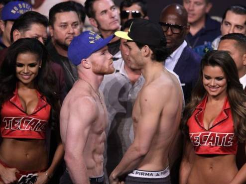 Boxers Saul 'Canelo' Alvarez (L) and Julio Cesar Chavez, Jr., face-off during their weigh-in Friday, May 5, 2017 at the MGM Grand Arena in Las Vegas, Nevada. Mexican bragging rights, and a possible middleweight world title shot, will be on the line in Las Vegas Saturday, May 6, 2017 when Saul 'Canelo' Alvarez takes on Julio Chavez Jr. in a Cinco de Mayo weekend fight. Alvarez, the reigning World Boxing Organization super welterweight world champion and a former middleweight world champ, is a heavy favorite as he steps up to a catchweight of 164.5 pounds (74.62 kg). / AFP PHOTO / JOHN GURZINSKI