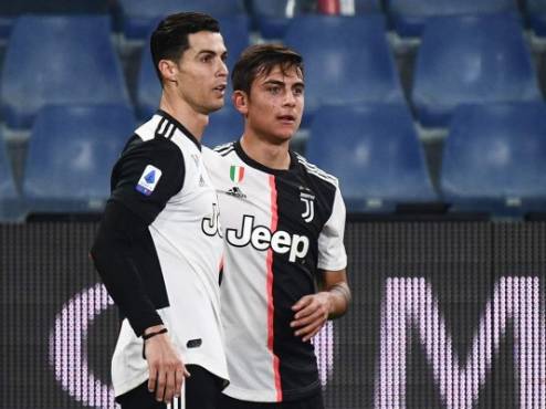 Juventus' Argentine forward Paulo Dybala (C) celebrates with Juventus' Portuguese forward Cristiano Ronaldo after opening the scoring during the Italian Serie A football match Sampdoria vs Juventus on December 18, 2019 at the Luigi-Ferraris stadium in Genoa. (Photo by Marco Bertorello / AFP)