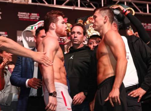 LAS VEGAS, NV - SEPTEMBER 14: Canelo Alvarez (L) and WBC/WBA middleweight champion Gennady Golovkin are held back after facing off during their official weigh-in at T-Mobile Arena on September 13, 2018 in Las Vegas, Nevada. Golovkin will defend his titles against Alvarez in a rematch on September 15 at T-Mobile Arena. Al Bello/Getty Images/AFP